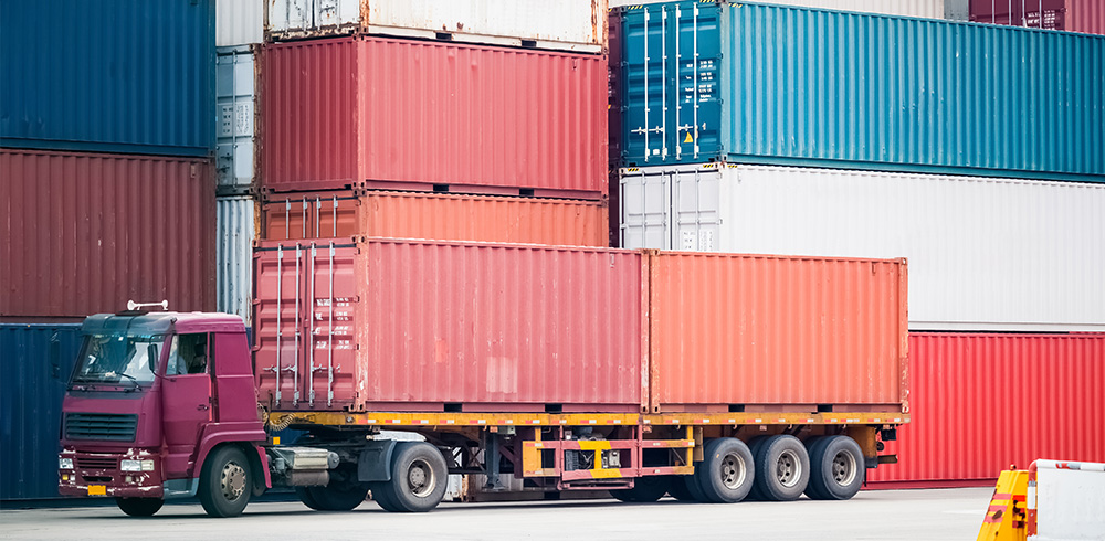 Steel cargo containers stacked in a container depot