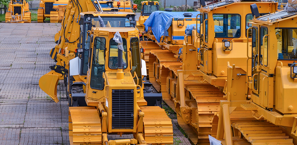 Construction vehicles parked in an outdoor lot